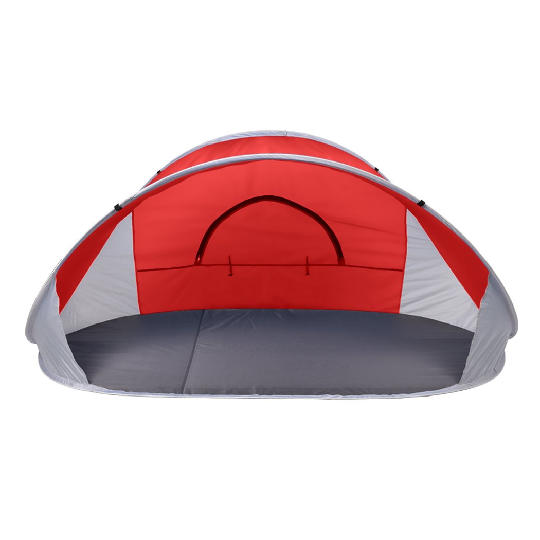 Mountvie Pop Up Tent in red color, spacious enough for 4 people, set up on a beach with a carry bag beside it.
